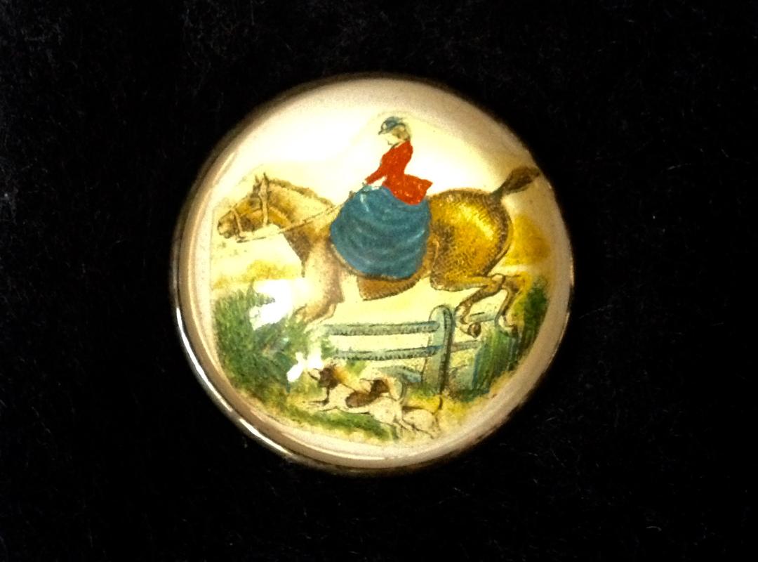 Pin Brass Rosette Featuring a Side Saddle Rider Taking a Hedge